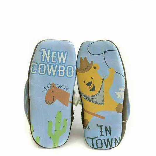 Baby Tin Haul boot soles with light blue illustrated cowboy, horse and cactus print, featuring bold western text