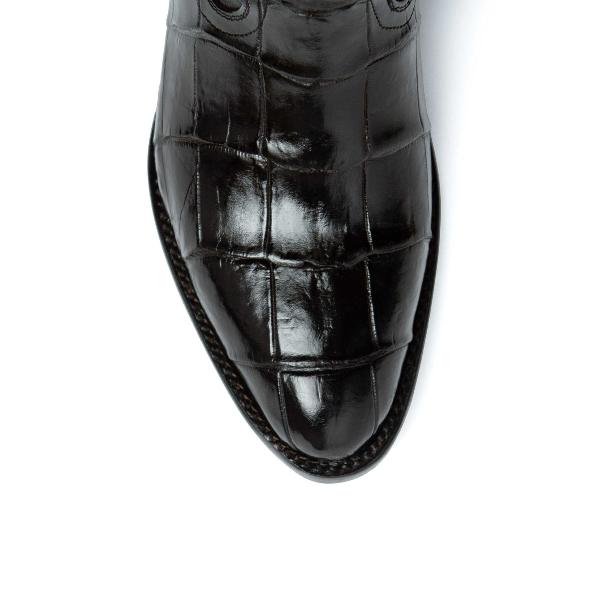 Men's Ferrini Stallion boot toe in glossy black alligator belly leather, showing distinctive rectangular scale pattern