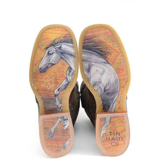 Women's Tin Haul cowboy boots with colorful horse artwork on orange and pink soles and brown leather uppers