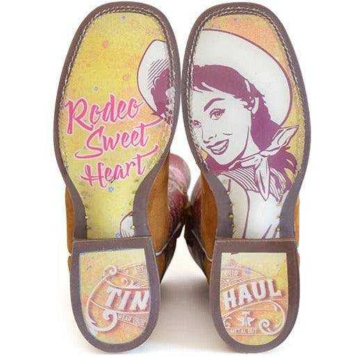 Women's Tin Haul Boots with brown leather soles, yellow and pink retro cowgirl graphics, and Rodeo Sweetheart lettering