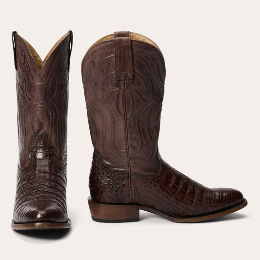 A handcrafted Stetson Boots Men’s Holliday Caiman Boot in tobacco, with a round toe and decorative stitching, is shown at an angle on a white background, reflecting classic American style.