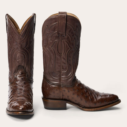 The Mens Stetson Chisholm Ostrich Boots by Stetson Boots are handcrafted in tobacco brown with decorative shaft stitching, a dotted ostrich foot, round toe, American roots style, low angled heel, and pull straps.