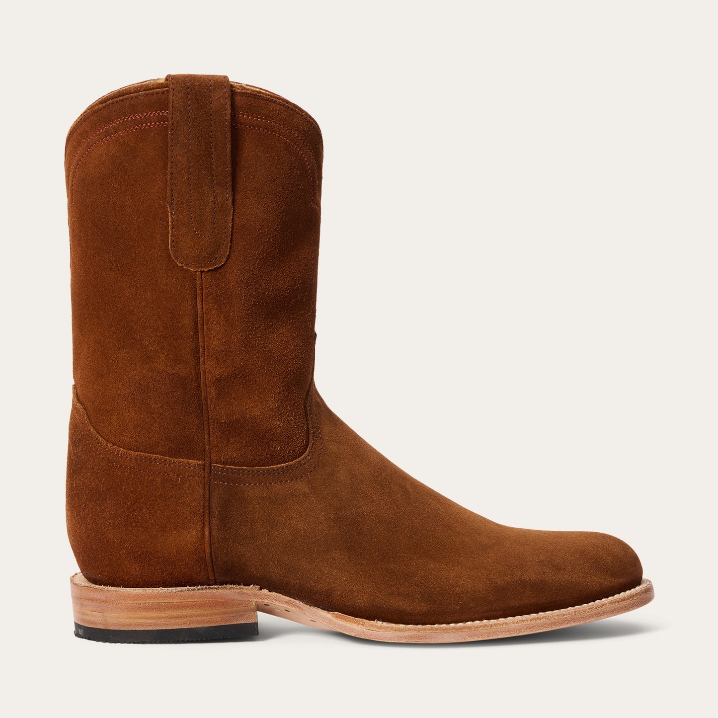 The Stetson Boots Mens Rancher Zip Roper features handcrafted cognac leather, a round toe, side zipper, and low heel—displayed on a white background and embodying timeless American roots.