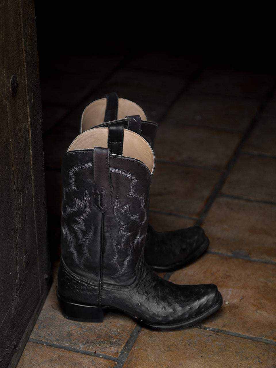 Men's Corral Black Genuine Full Quill Ostrich Boots in black textured leather with dark Western embroidery, tan pull straps and square toes