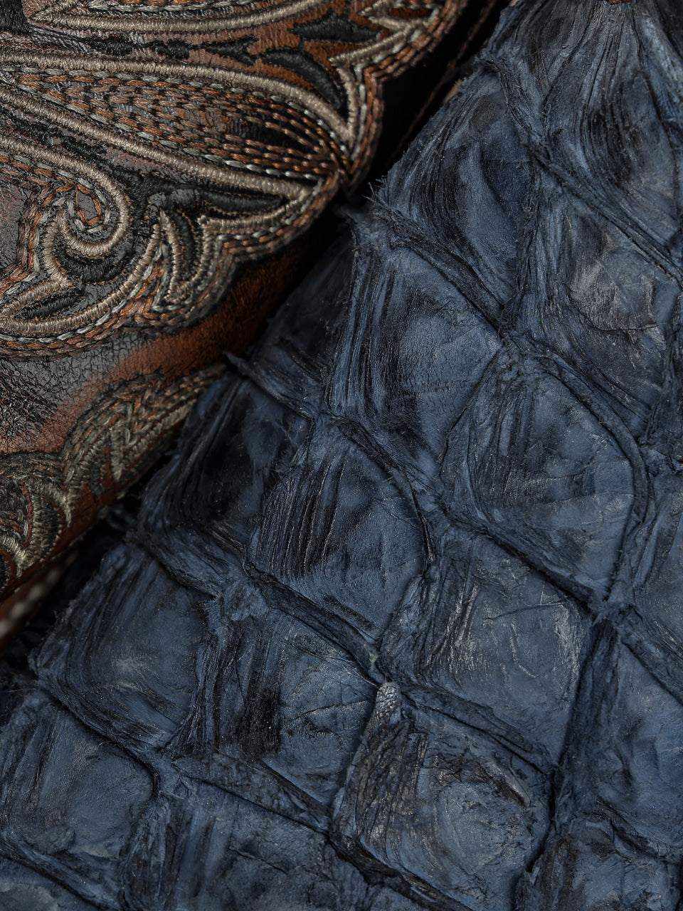 Close-up of Men's Corral Blue Genuine Pirarucu Fish Boots with Embroidery showing blue textured pirarucu fish leather and brown embroidered cowhide shaft
