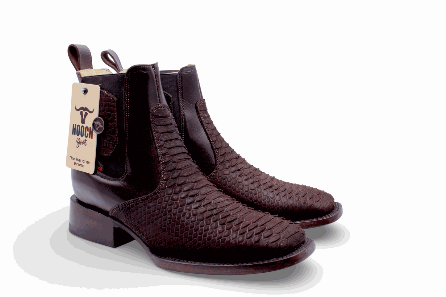 Pair of brown leather boots with a visible brand tag on a white background