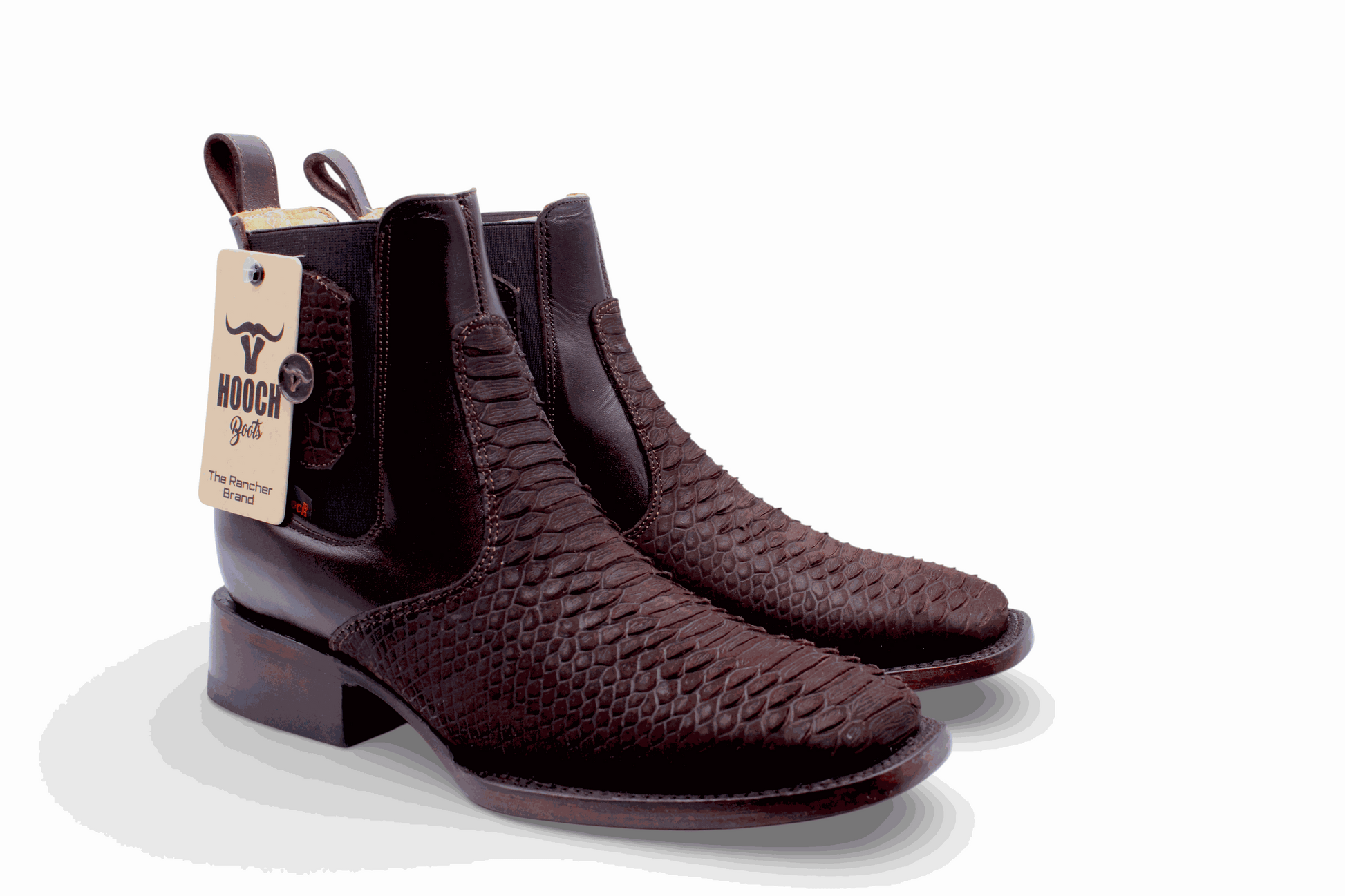 Pair of brown leather boots with a visible brand tag on a white background