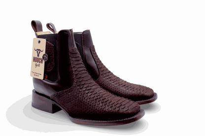Pair of brown leather boots with a visible brand tag on a white background