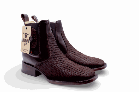 Pair of brown leather boots with a visible brand tag on a white background