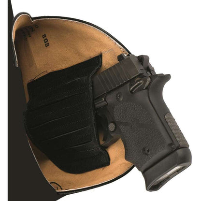 Roper Pierce Concealed Carry Boots feature a brown leather interior and black elastic retention strap holding a handgun securely.