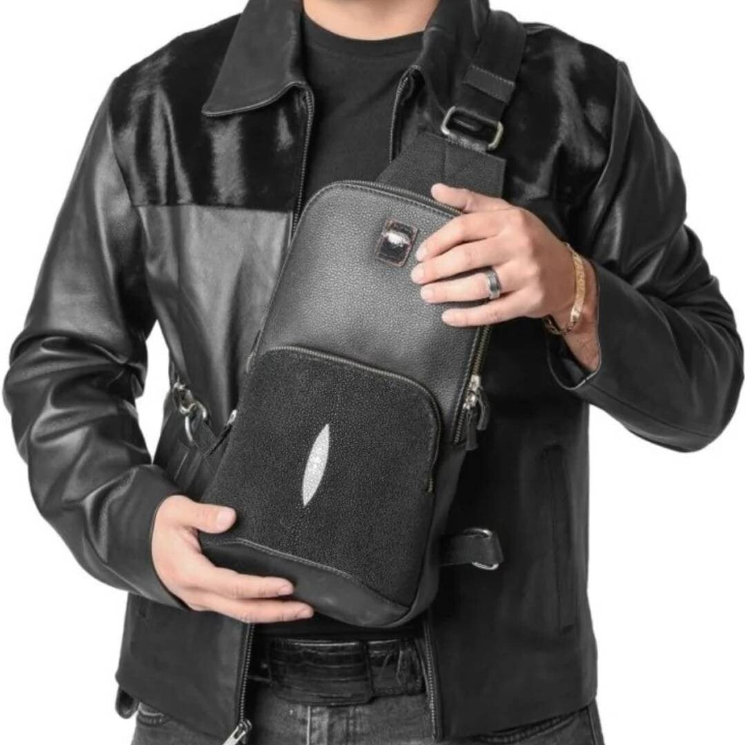 Person holding a black shoulder bag 