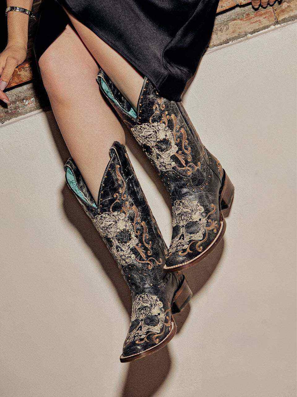 Women's Corral Black Genuine Leather Boots with Floral Skull, ornate floral skull embroidery, studs, pointed toes, and stacked heels