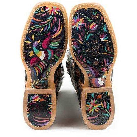 Women's Tin Haul Ooh La La Boots with black soles covered in colorful floral designs and tan leather edging