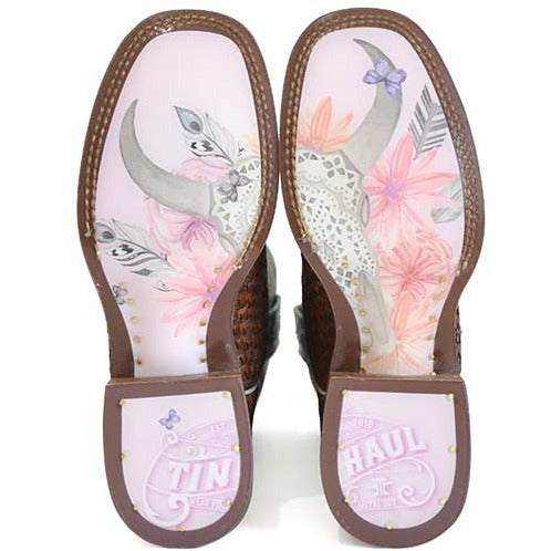 Women's Tin Haul Boots shown from below with brown leather soles, pink floral artwork, bird details and branded heels