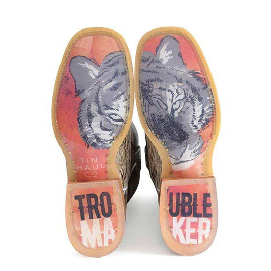 Women's Tin Haul Boots with tan leather soles featuring gray wolf artwork and bold pink Trouble Maker lettering